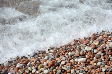 Coast. Waves hitting the pebbles. Sea waves.