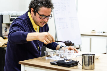 Professional barista testing the taste of a new coffee