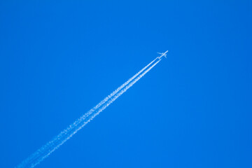 Airplane flying in clear blue sunny weather