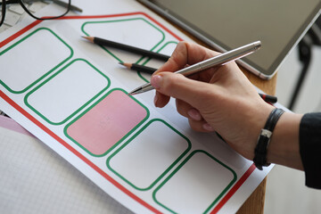 Woman's hand puts mark in cadastral, map