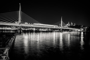 black and white photo of Golden Horn Bridge at night. Istanbul, Turkey