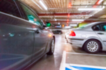 Rent parking space blurred. Car lot parking space in underground city garage. Empty road asphalt background in soft focus. Parking space search, No parking space.