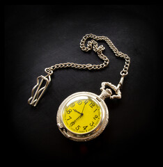 Fototapeta na wymiar Old vintage retro antique beautiful silver pocket watch on a chain isolated on black background flat lay top view.