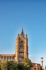 Fototapeta premium St Peter Mancroft church spire against a bright blue sky in the city of Norwich in Norfolk