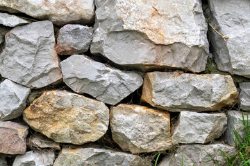 Stone wall with stacked natural stones