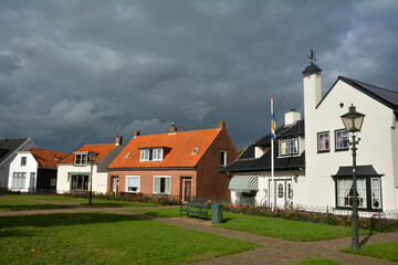 Street and houses in the town of Renesse with dark sky