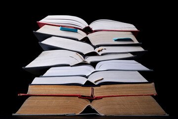 A stack of books on the desk. Old extensive literary publications.