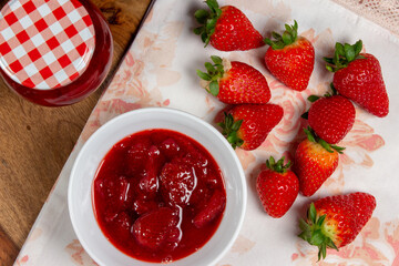 Homemade strawberry jam. Fresh strawberries and jars of freshly prepared jam.