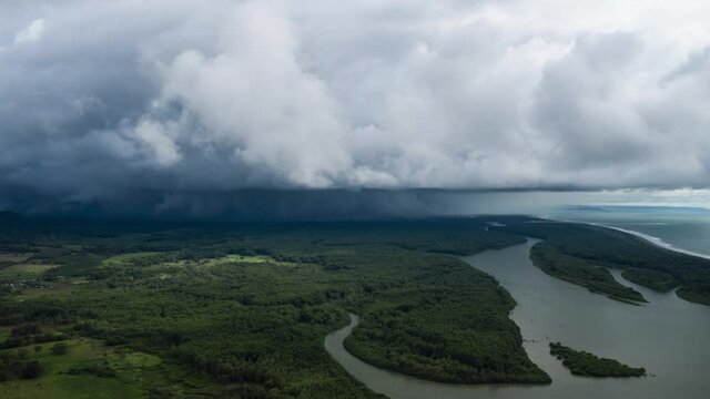 aerial time lapse of a rainy storm clouds over the mangrove river by the pacific ocean Costa Rica