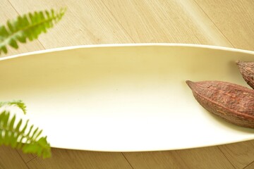Top view photo of  White bowl.  with Cacao pod. 

white sign board with copy space. 
blurred background soft focus image.