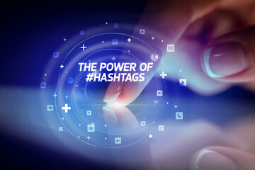 Finger touching tablet with social media icons and THE POWE OF #HASHTAGS