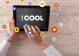 Close-up of a touchscreen with #COOL inscription, social networking concept