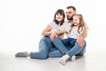 Cheerful happy couple with their little daughter on white background