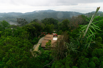 Fototapeta premium Birds eye view of a village with a beautiful forest