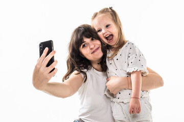 Happy woman and child taking a selfie isolated on white background