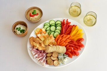 Healthy appetizer charcuterie platter with cheese, vegetables and crackers for party buffet food. Photo concept, background food, copy space