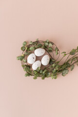 Speckled chocolate easter eggs in heart-shaped leaves nest