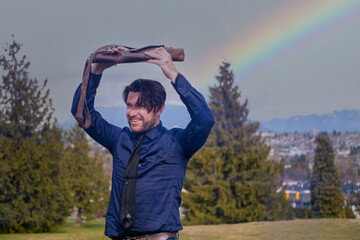 Fototapeta na wymiar 突然の雨に鞄で身を隠しながら走る男と虹