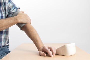 putting on a blood pressure cuff for a home blood pressure monitor
