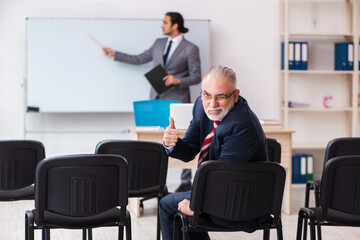 Two businessmen in the classroom in pandemic concept