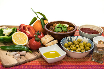 Obraz na płótnie Canvas Mediterranean food - cooked meat, olives, yogurt, vegetables, olive oil - on a wooden table and white background-2