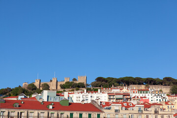 Fototapeta na wymiar View of old town and hilltop castle in Lisbon . Castelo de S. Jorge situated on the mountain top in Lisboa Portugal