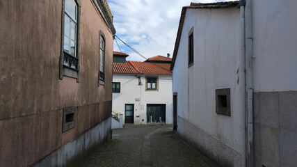 Fão, Esposende, Portugal - January 10, 2021: Located on the Cávado River’s left bank, the typical village of Fao is characterized by a marked neighborhood spirit. The narrow Sao Tome Street.