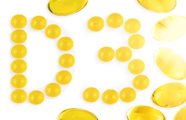 Papier Peint photo K2 Small Vitamin D3 capsules forming letter D and number 3, with Omega3 capsules around isolated