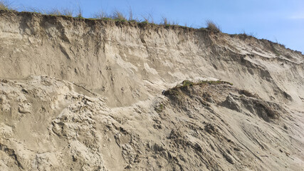 Post-storm eroded dune in Esposende, Portugal. Sand loss from a dune under wave attack.