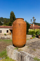 Fototapeta na wymiar A big jar stands in the green garden of a large mansion estate near Esposende, Portugal.