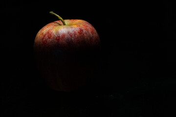 Red apple on black background

