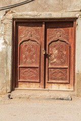Carved wooden door on a building in Oman.