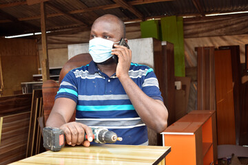 Black African carpenter working with carpentry  equipment in a  carpenter's workshop
