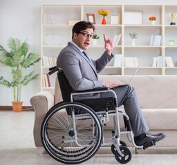 Dsabled businessman on wheelchair working home