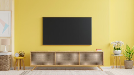 Mockup a TV wall mounted in a living room room with a yellow wall.