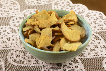 Rye wheat bread bite snack in a ceramic snack bowl on lace