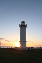 View of a light house with sunrise as background