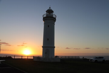 View of a light house with sunrise as background