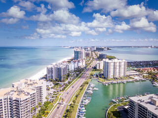 Spring break or Summer vacations in Florida. Ocean beach and Resorts in US. Blue-turquoise color water. American Coast or shore. Island in Gulf of Mexico. Clearwater Beach FL. Aerial view of city.