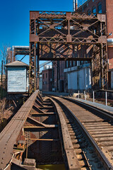 Fototapeta na wymiar Abandoned crane over railroad track