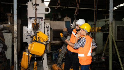 Team of female and male mechanical engineer or worker work together to check the operation system in a factory