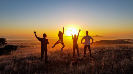 Group of friends enjoying sunset 