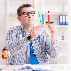 Young student studying chemistry in university