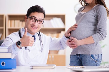 Fototapeta premium Pregnant woman visiting doctor for consultation