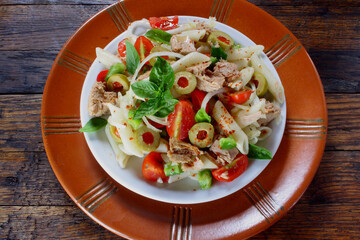 Tuna salad with pasta, olives and tomato