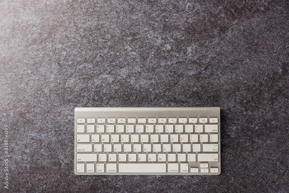 Aufkleber top view flat lay of a modern white computer keyboard on office desk concrete background with copy s
