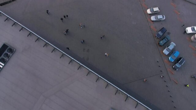 Tilt Up Aerial Shot Of Exterior Of Zalgiris Arena, Kaunas, Lithuania. People Walking Outside.