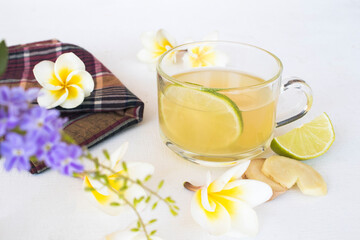 Fototapeta na wymiar herbal healthy drinks ginger ,lemon cocktail water with purple flower ,frangipani arrangement flat lay style on background white 