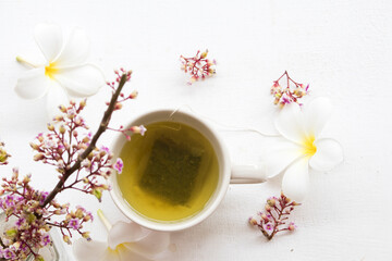 herbal health drinks hot green tea with flowers arrangement flat lay style on background white 