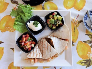 shrimp quesadilla with dressing on the plate
